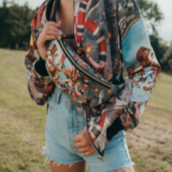 Female model wearing luxury softshell bomber jacket and matching bum bag in a maximalist Circus inspired design