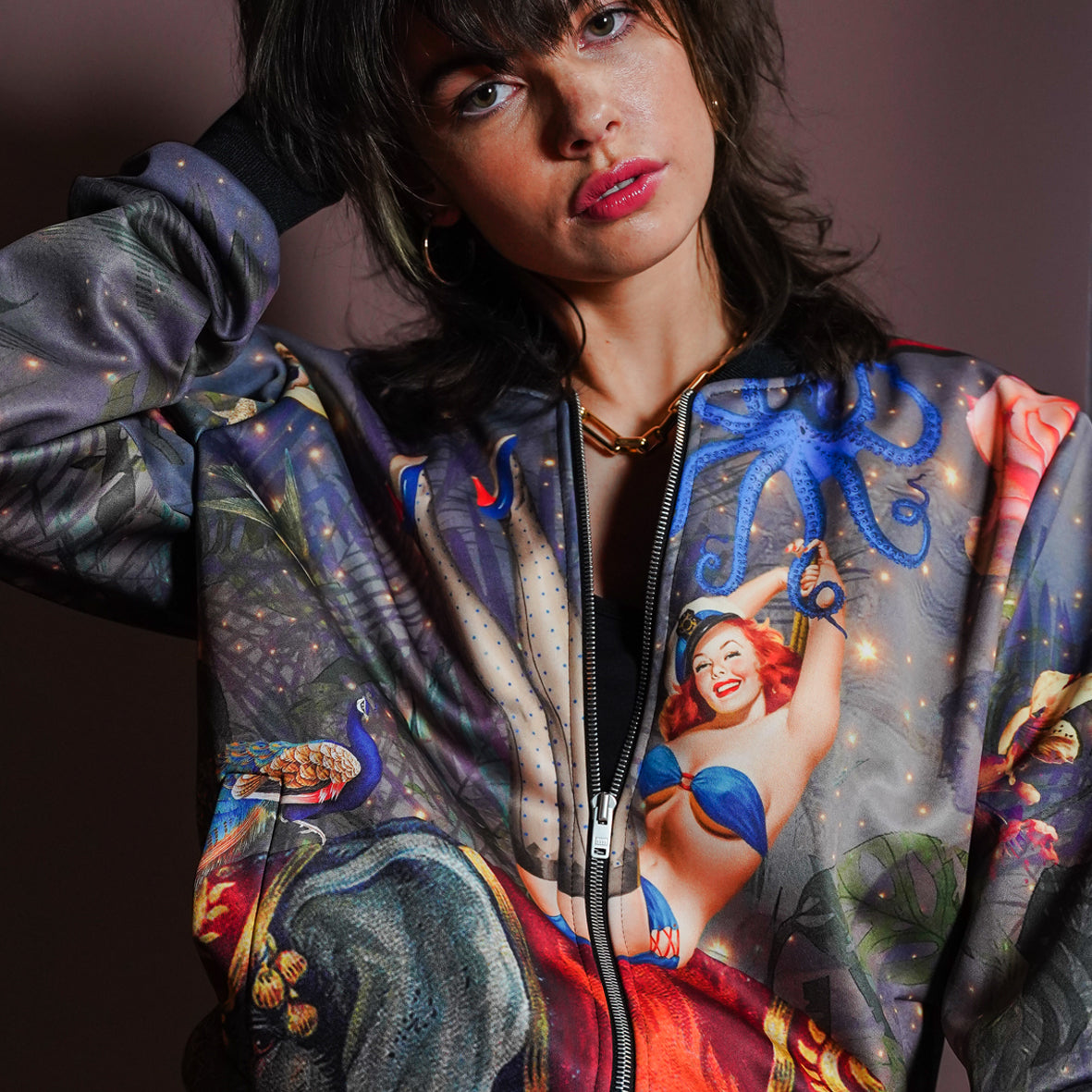 A female model weariing luxury softshell bomber jacket in a maximalist retro pinup design
