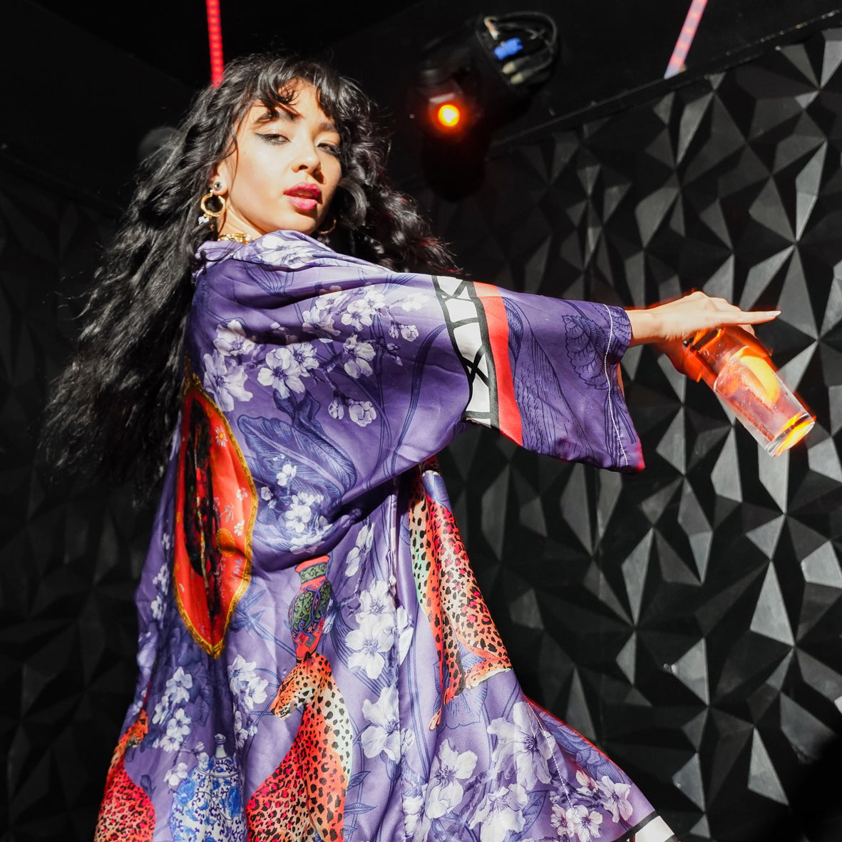 Female model in a Bar wearing luxury 100% silk Kimono in a blue maximalist oriental inspired design