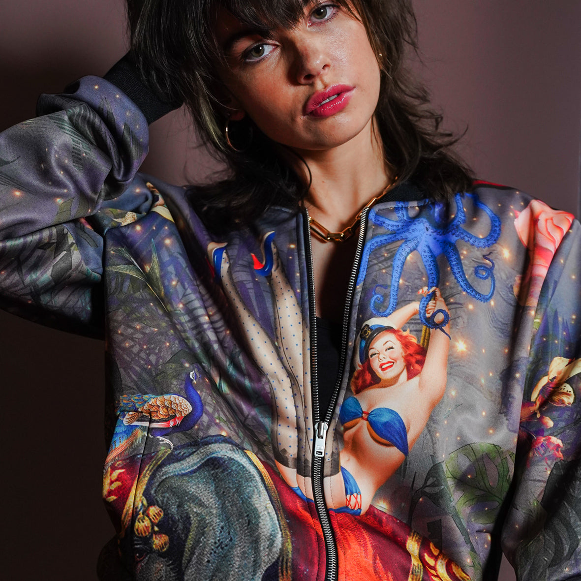 A female model weariing luxury softshell bomber jacket in a maximalist retro pinup design 