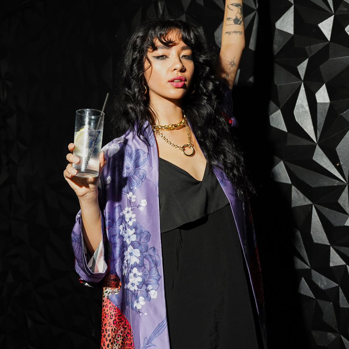 Female model in a Bar wearing luxury 100% silk Kimono in a blue maximalist oriental inspired design