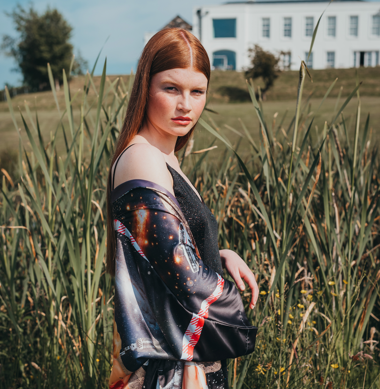 A female model outdoors wearing a luxury 100% silk kimono in a maximalist retro Pin Up design